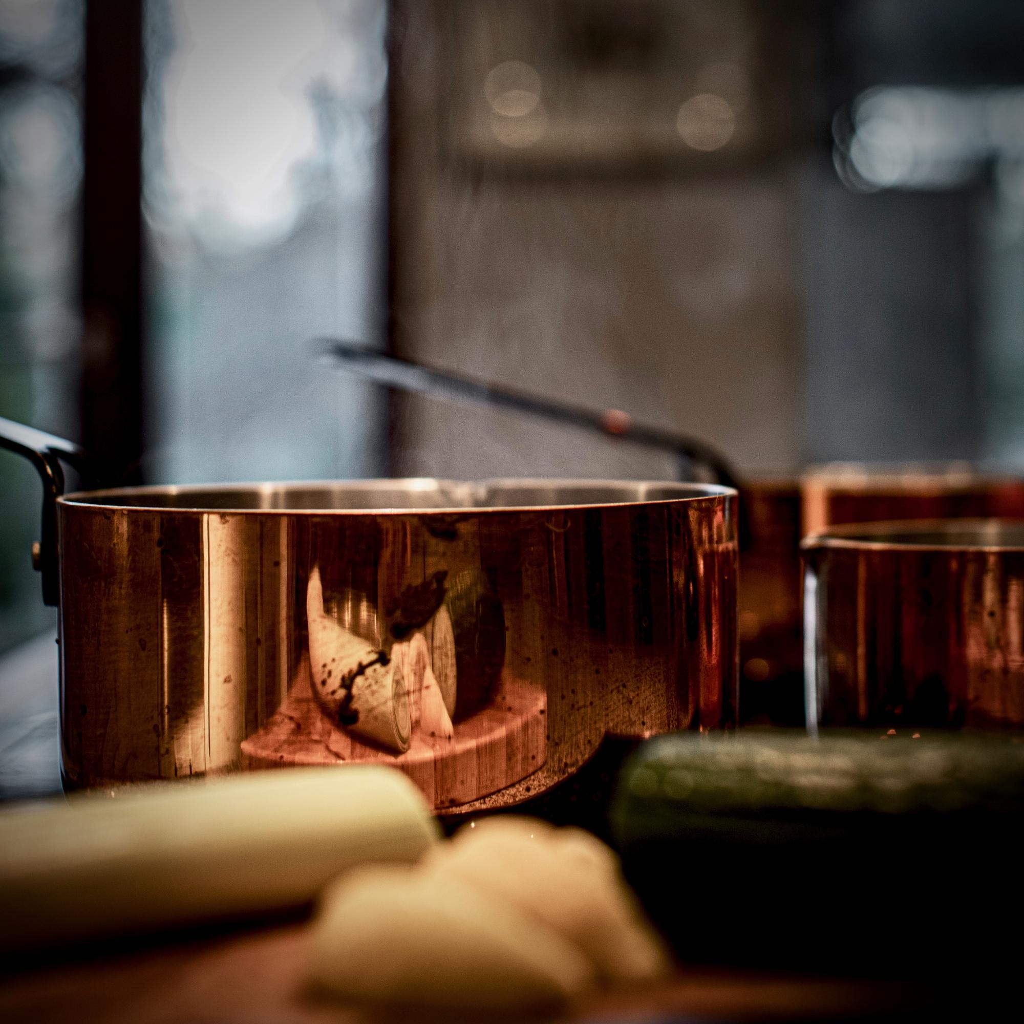 Interior of a refined cooking studio with copper pans
