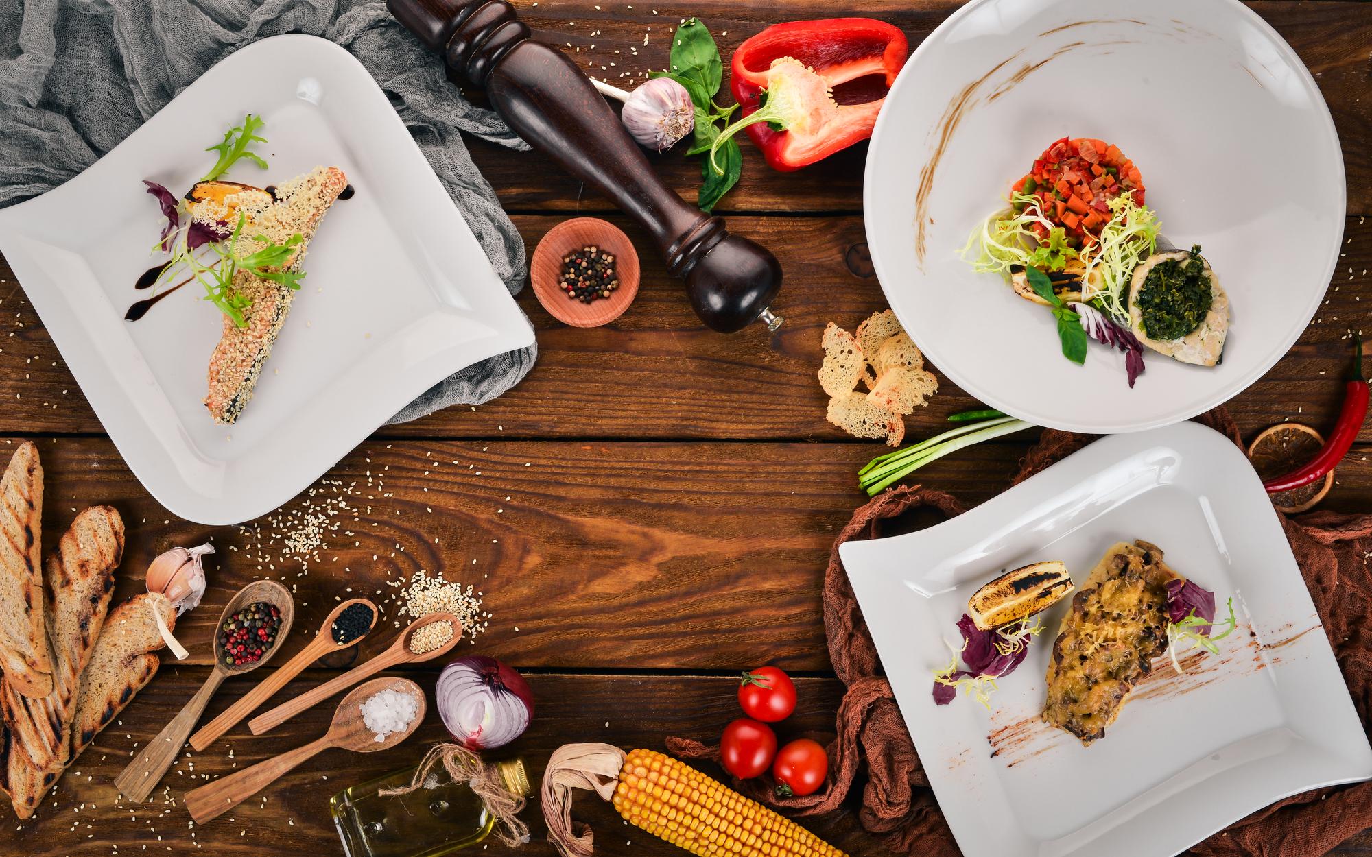 Assorted plated courses on a wooden table